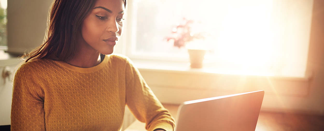 Image of a young lady looking into her laptop computer.