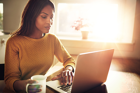 Image of a young lady looking into her laptop computer.