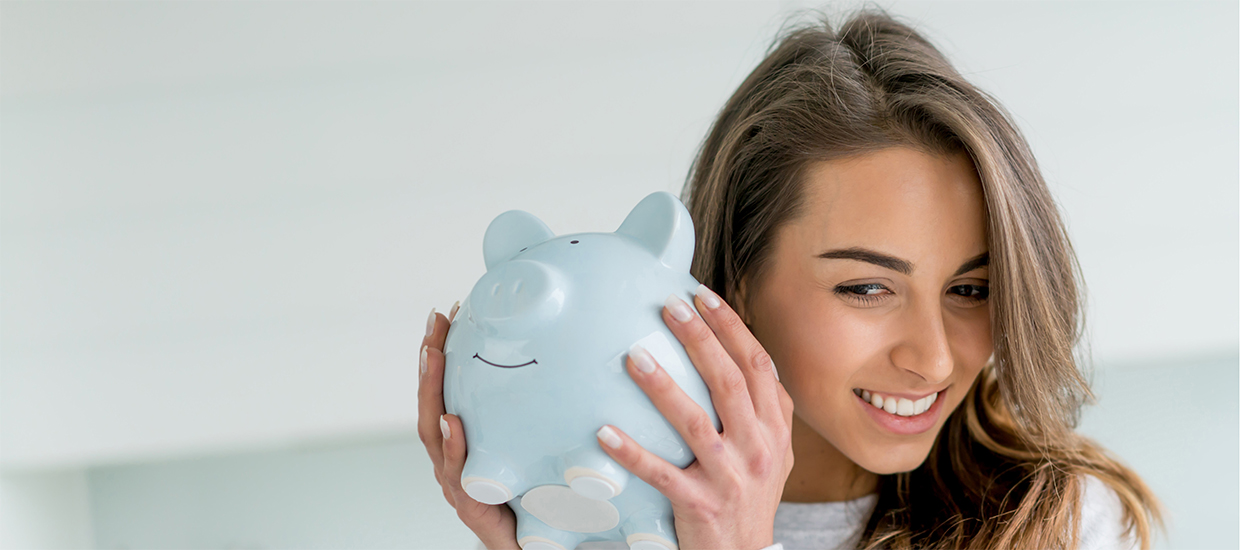 Image of a woman holding a piggy bank